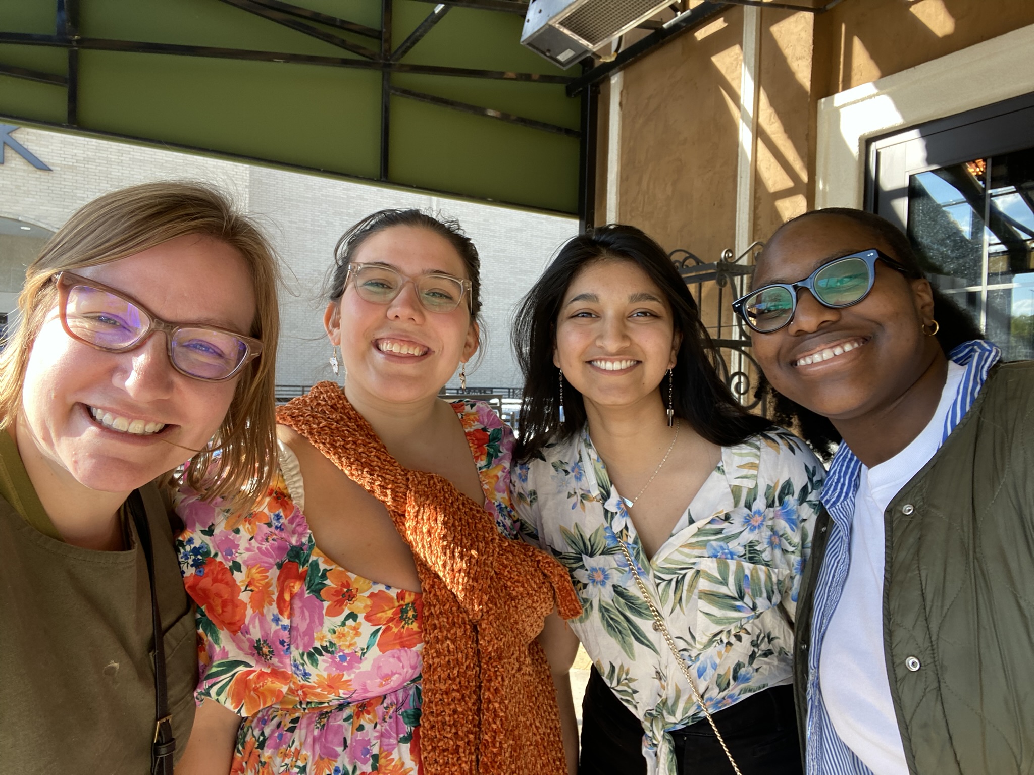 four people smiling